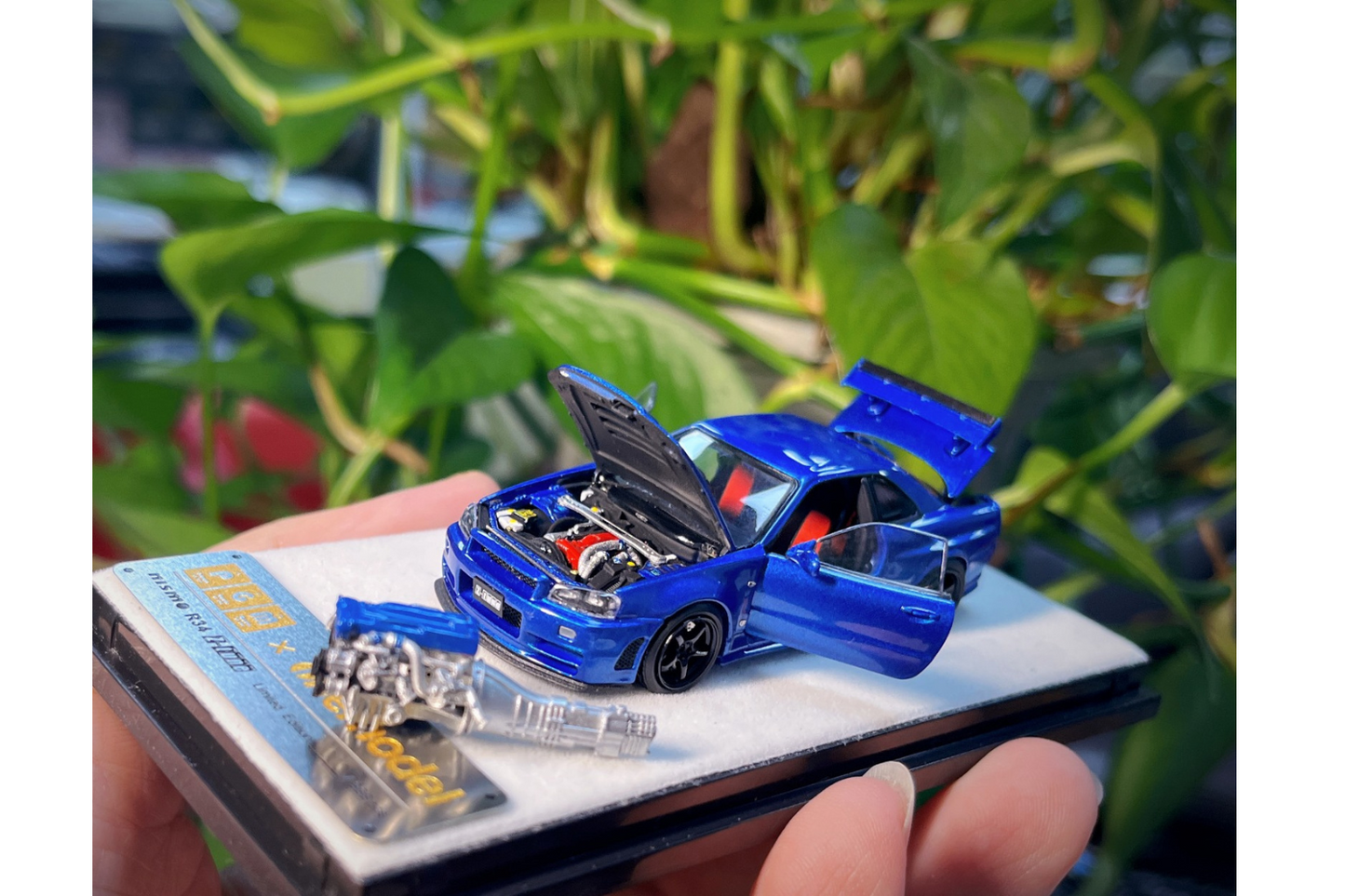 PGM x One Model 1:64 Nissan Skyline GT-R (R34) Z-Tune in Bayside Blue on Standard Base