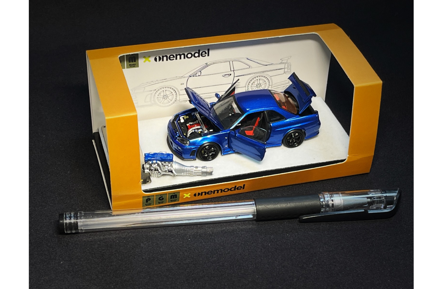 PGM x One Model 1:64 Nissan Skyline GT-R (R34) Z-Tune in Bayside Blue on Standard Base