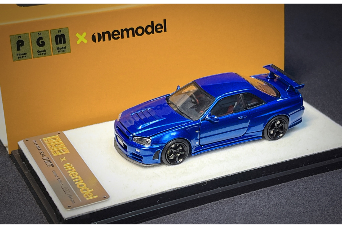 PGM x One Model 1:64 Nissan Skyline GT-R (R34) Z-Tune in Bayside Blue on Standard Base