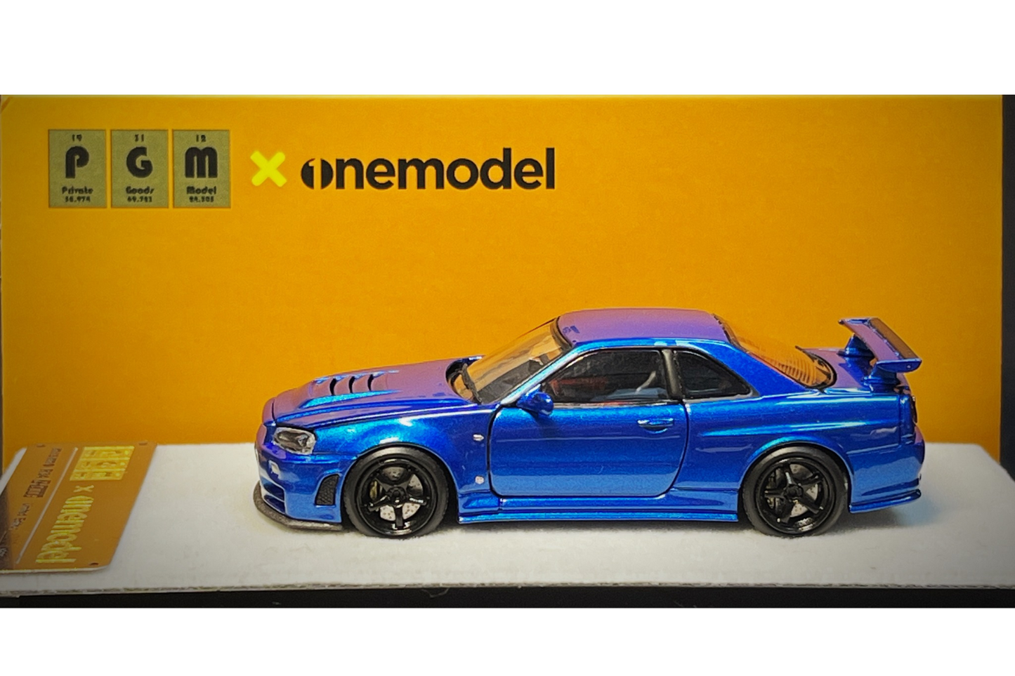 PGM x One Model 1:64 Nissan Skyline GT-R (R34) Z-Tune in Bayside Blue on Standard Base