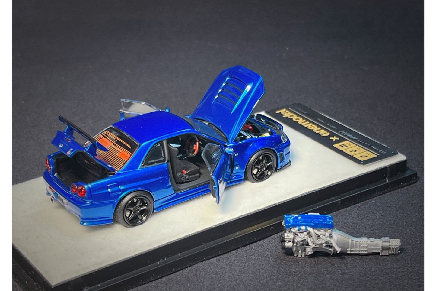 PGM x One Model 1:64 Nissan Skyline GT-R (R34) Z-Tune in Bayside Blue on Standard Base