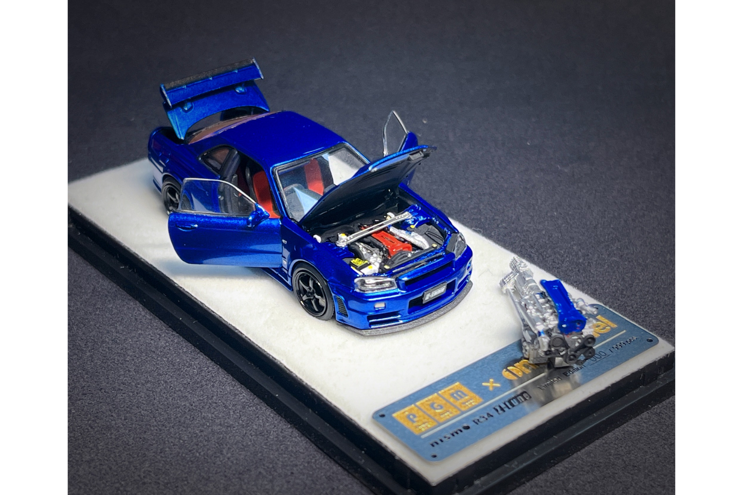 PGM x One Model 1:64 Nissan Skyline GT-R (R34) Z-Tune in Bayside Blue on Standard Base